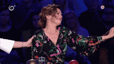 Woman At Table With Number 12 On Screen GIF