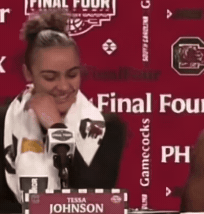 Woman At Table With Tessa Johnson Sign GIF