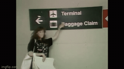 Woman At Terminal Baggage Claim Sign GIF