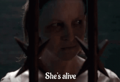 Woman Behind Bars Saying Alive GIF