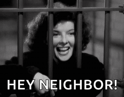Woman Behind Bars Saying Hey Neighbor GIF