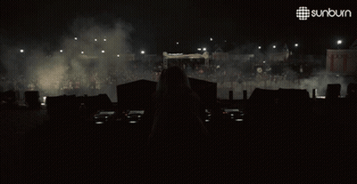 Woman Behind DJ Booth With Sunburn Logo GIF