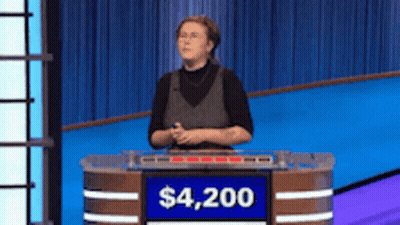 Woman Behind Podium With Sign Saying $4,200 GIF