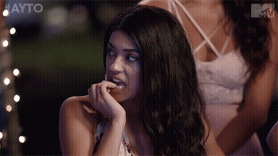 Woman Biting Nails In Front Of Group GIF