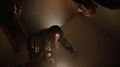 Woman Black Jacket Red Pants Dark Hallway GIF