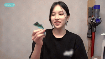 Woman Black Shirt Holding Toy Mina TV Vacuum GIF