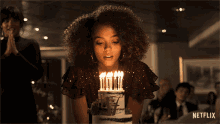 Woman Blowing Birthday Candles On Cake GIF