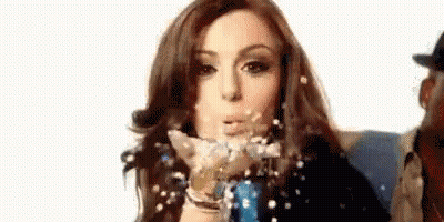 Woman Blowing Confetti GIF