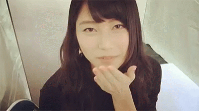 Woman Blowing Kiss At Camera In Front Of Mirror GIF