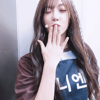Woman Blowing Kiss In Apron With Korean Writing GIF