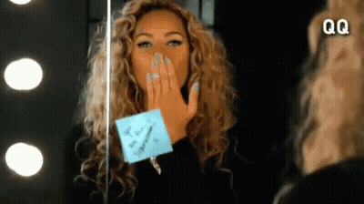 Woman Blowing Kiss In Front Of Mirror With QQ GIF