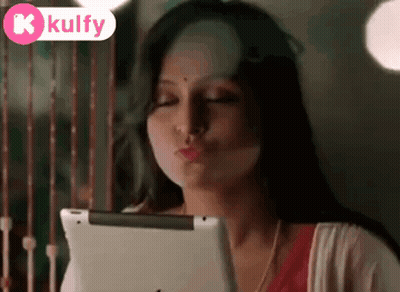 Woman Blowing Kiss Looking at Tablet