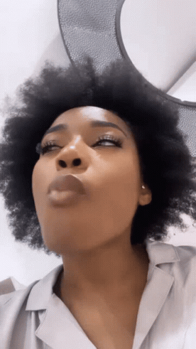 Woman Blowing Kiss With Eyes Closed GIF