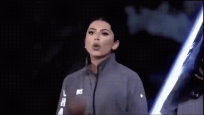 Woman Blowing Kiss With Lightsaber In Dark GIF