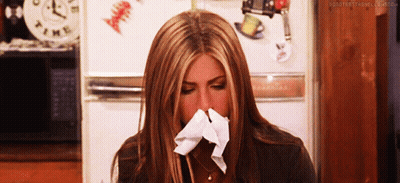 Woman Blowing Nose In Front Of Clock Saying Time GIF