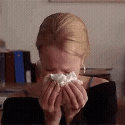 Woman Blowing Nose Into Napkin While Crying GIF