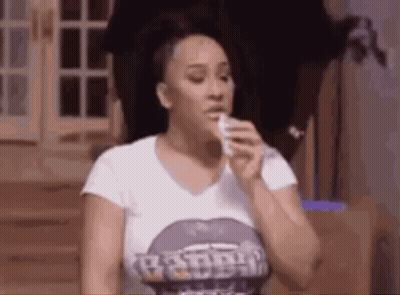 Woman Blowing Nose With Tissue In Purple Shirt GIF