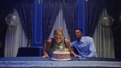 Woman Blowing Out Birthday Cake Candles With Sprinkles GIF