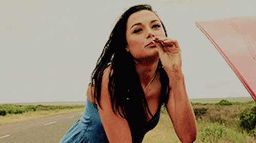 Woman Blue Dress Blowing Kiss Leaning Car Hood GIF