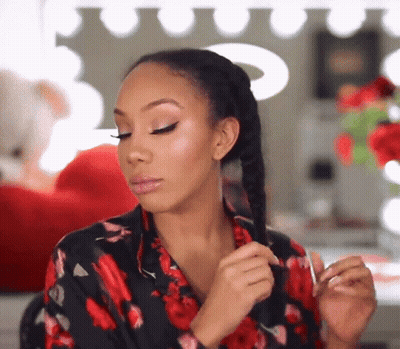 Woman Braiding Hair In Front Of Mirror GIF