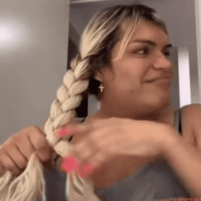 Woman Braiding Hair Smiling Cross Earring GIF