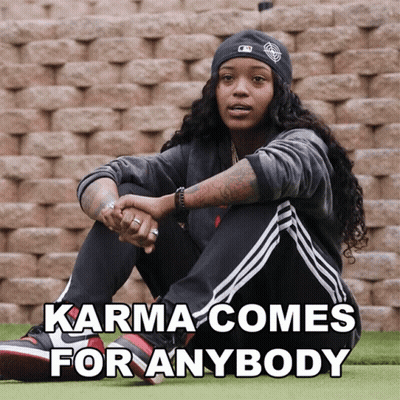 Woman By Brick Wall Saying Karma Comes For Anybody GIF