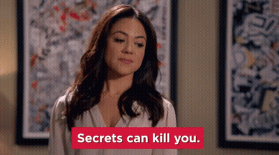 Woman By Painting With 'Secrets Can Kill You' Sign GIF