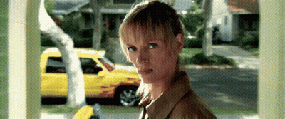 Woman By Yellow Truck Looking At Camera GIF