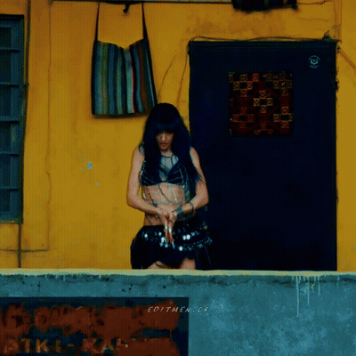 Woman By Yellow Wall With Editmen.cr Sign GIF