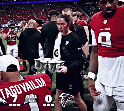 Woman Carrying Tray Of Gatorade In Falcons Jersey Number 7 GIF