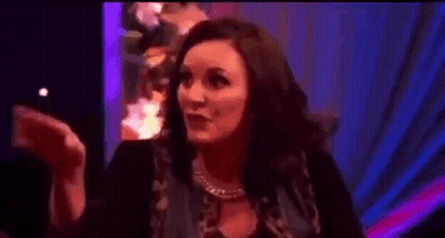 Woman Clapping In Dark Room With Purple Light GIF