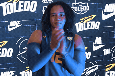 Woman Clapping In Front Of Toledo Wall GIF