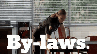 Woman Cleaning Table With By-Laws GIF