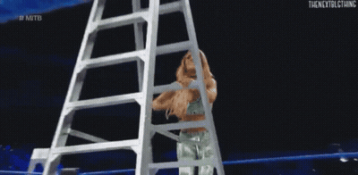 Woman Climbing Ladder In Wrestling Ring GIF