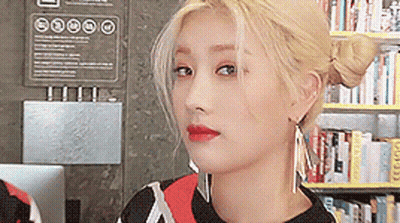 Woman Close Up In Front Of Bookshelf GIF