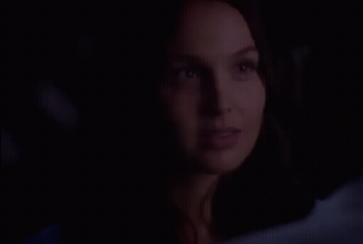 Woman Close Up Smiling In Dark GIF