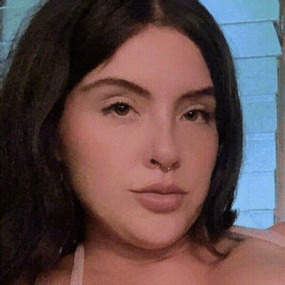 Woman Close Up With Blue Wall Background GIF