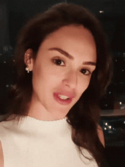 Woman Close Up With White Shirt And Earrings GIF