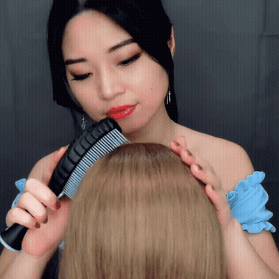 Woman Combing Another's Hair GIF