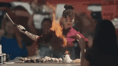 Woman Cooking On Grill With Flames From Hands GIF