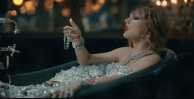 Woman Covered In Ice In Bathtub Holding Necklace GIF