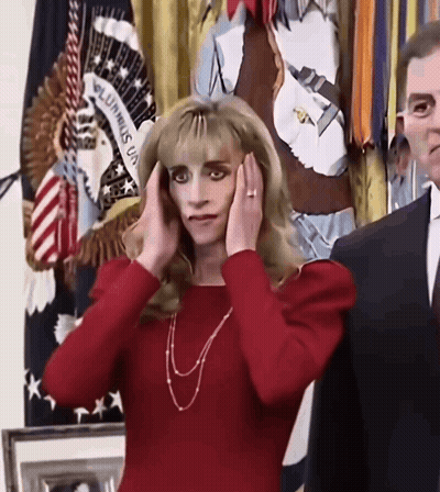 Woman Covering Ears In Front Of Unum Flag GIF