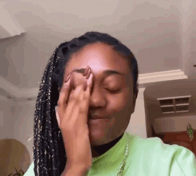 Woman Covering Eyes In Green Shirt GIF