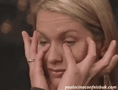 Woman Covering Eyes Looking At Camera GIF