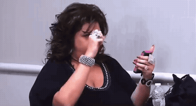 Woman Covering Face Holding Cell Phone And Water Bottle GIF
