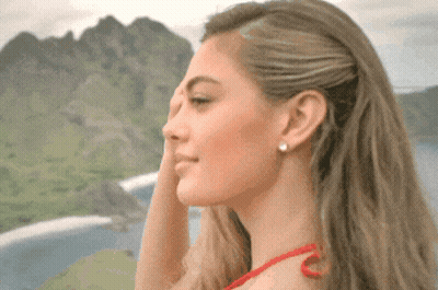 Woman Covering Face In Front Of Mountains GIF