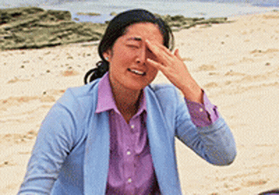 Woman Covering Face On Beach GIF