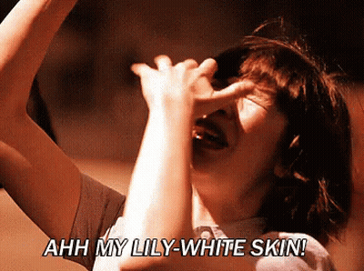 Woman Covering Face Saying Ahh My Lily-White Skin GIF