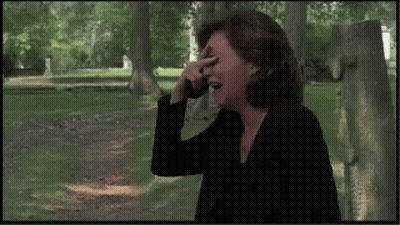 Woman Covering Face While Talking On Cell Phone GIF