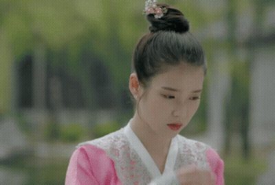 Woman Covering Face With Hand Wearing Earrings GIF